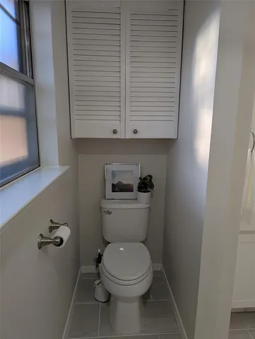 a white toilet sitting next to a sink