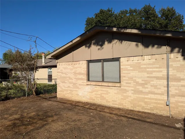 a side view of a house with a yard