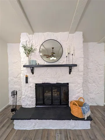a living room with a fireplace and a wooden floor