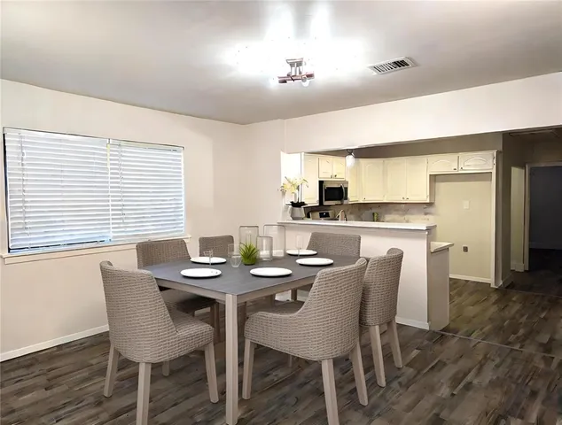 a dining room with furniture and window