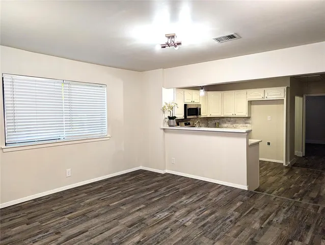a view of a kitchen with wooden floor