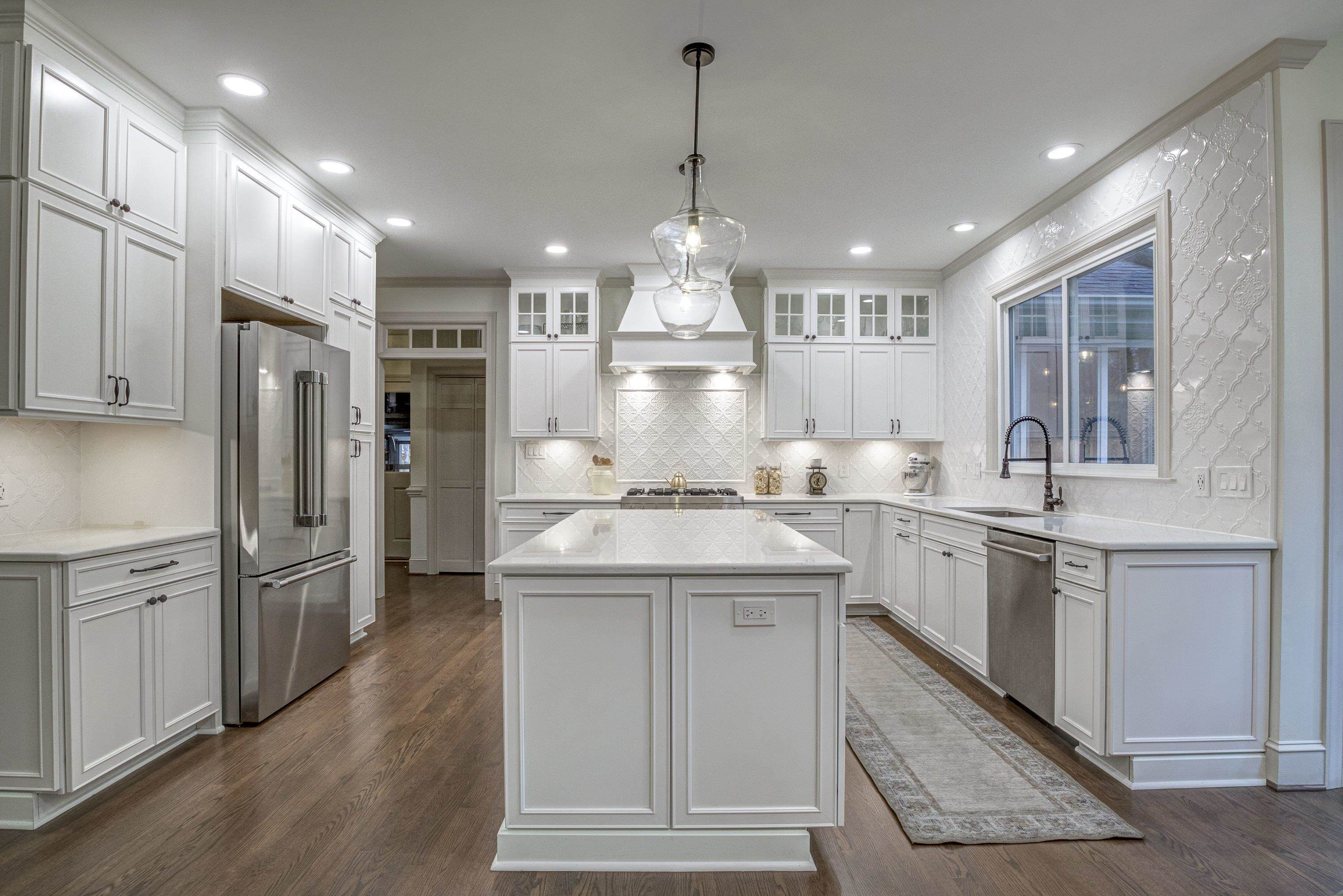 1413 Paumier Court Raleigh, NC 27615 - Photo 16 of 61 a kitchen with white cabinets and stainless steel appliances