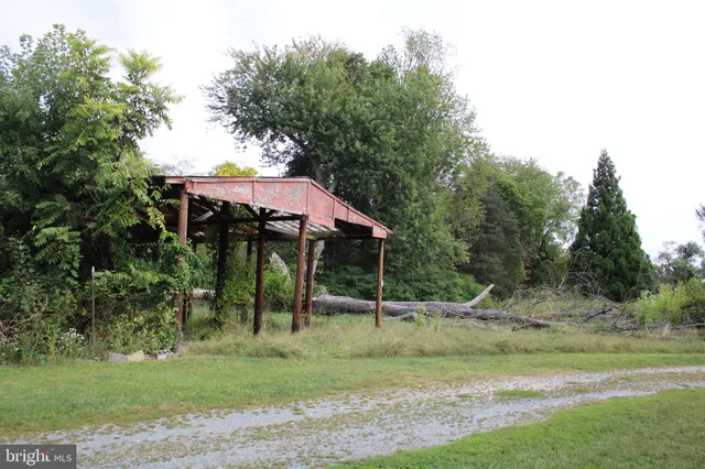 a backyard of a house with barbeque oven