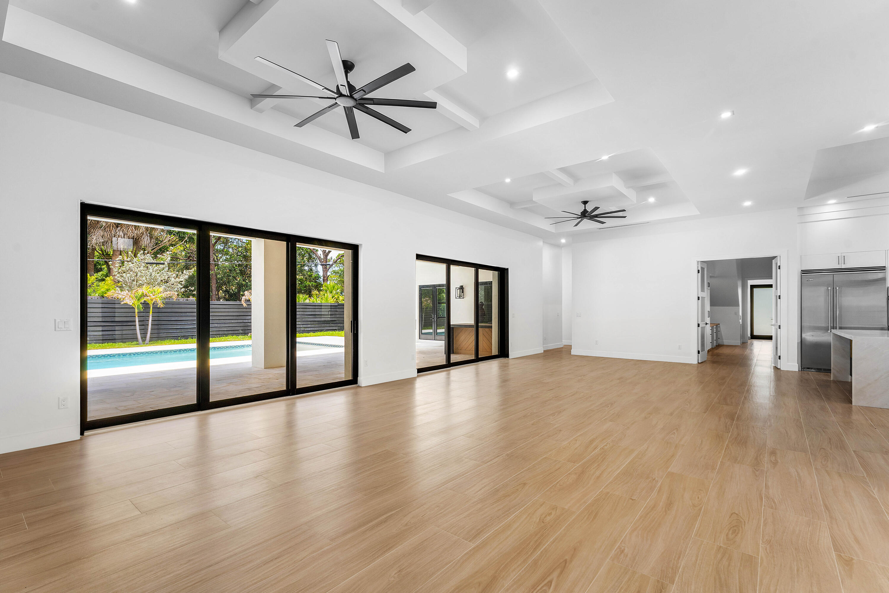 5701 Old Orange Road Jupiter, FL 33458 - Photo 14 of 46 a view of empty room with wooden floor and a ceiling fan