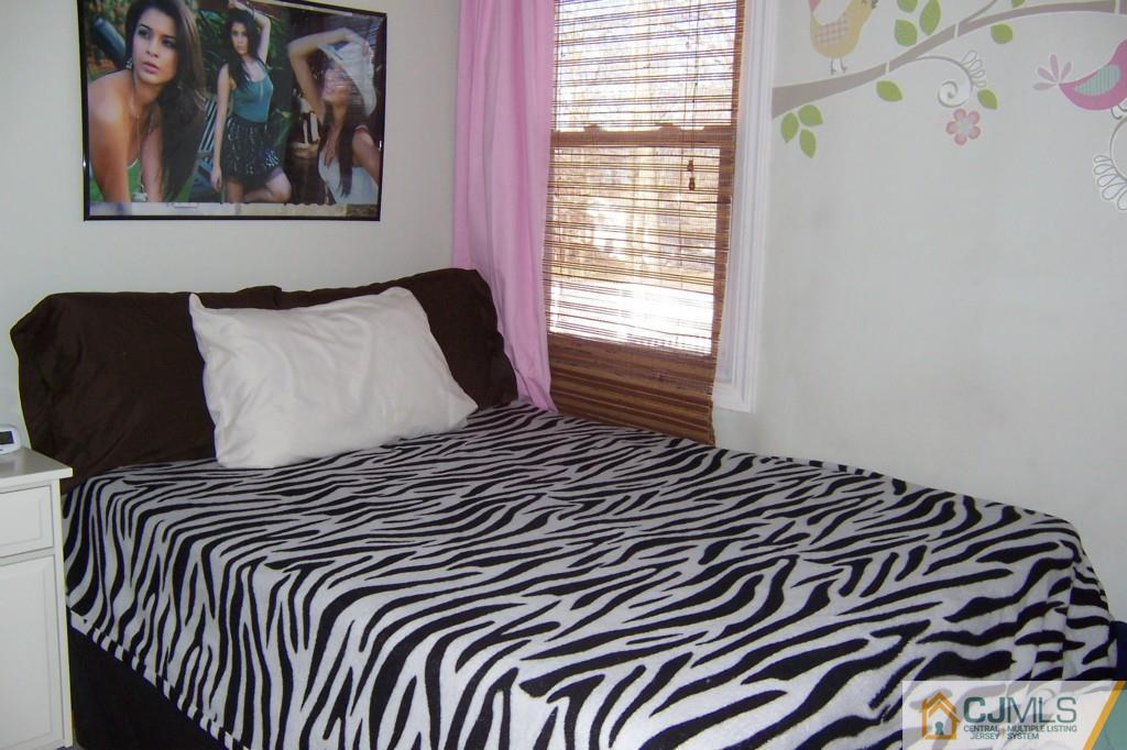 138 South Hill Road Colonia, NJ 07067 - Photo 12 of 25 a bedroom with a bed and a painting on the wall