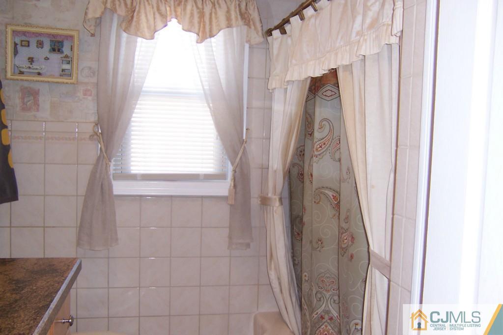 138 South Hill Road Colonia, NJ 07067 - Photo 15 of 25 a bathroom with a shower and a window