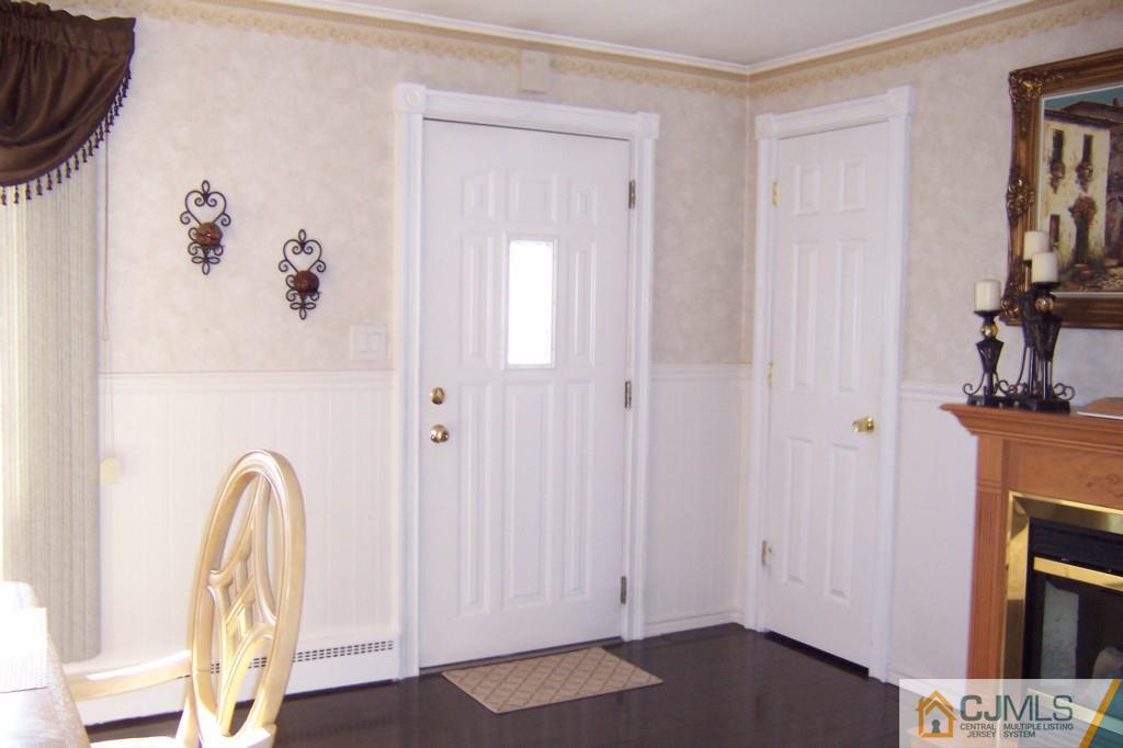 138 South Hill Road Colonia, NJ 07067 - Photo 3 of 25 a view of a livingroom with a fireplace wooden floor and closet area