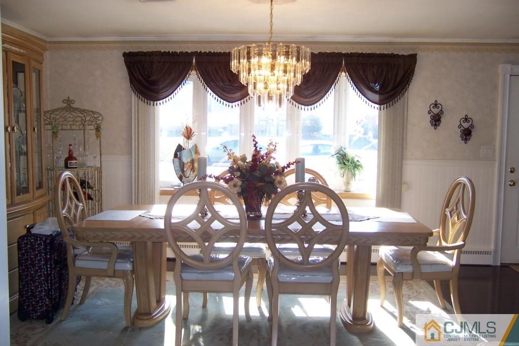 138 South Hill Road Colonia, NJ 07067 - Photo 5 of 25 a view of a dining room with furniture a chandelier and wooden floor