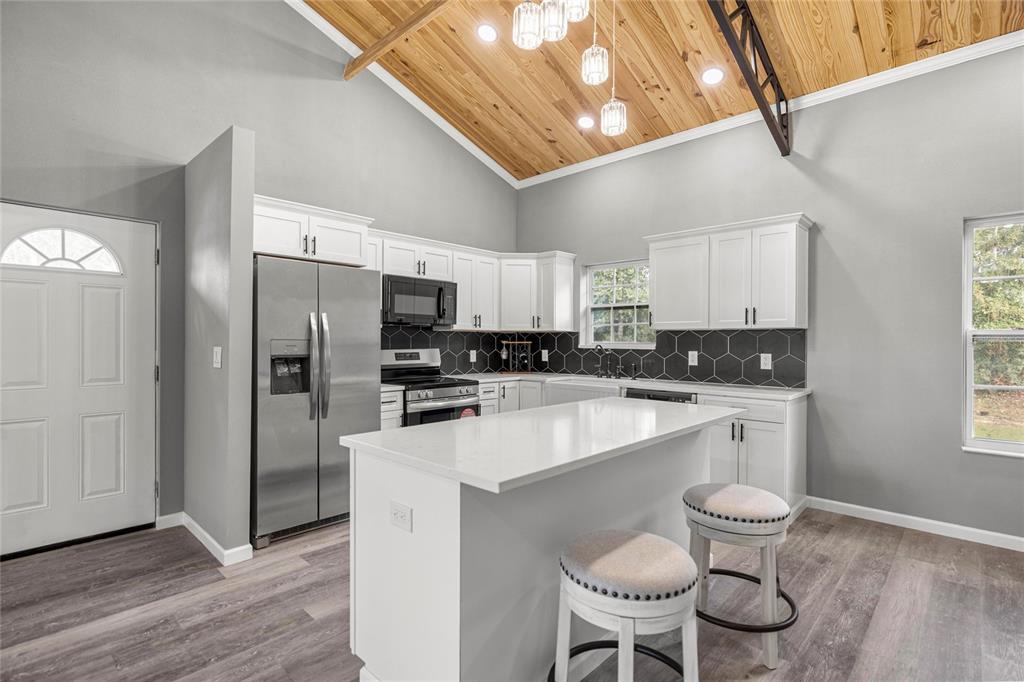15010 Northeast 3rd Place Williston, FL 32696 - Photo 17 of 32 a kitchen with a sink cabinets and refrigerator