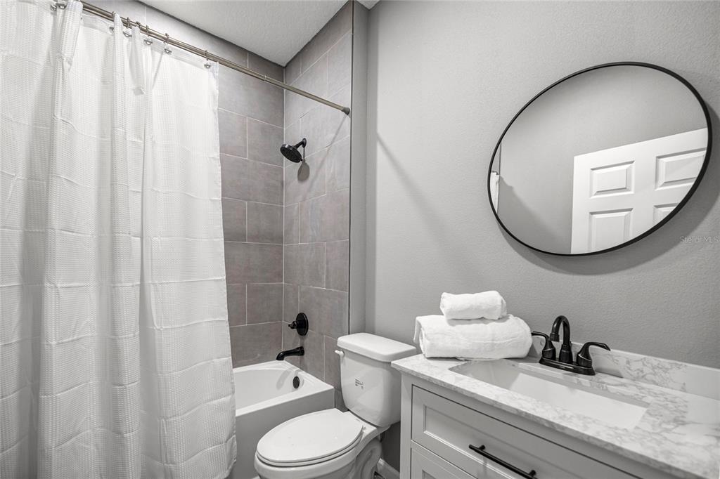 15010 Northeast 3rd Place Williston, FL 32696 - Photo 28 of 32 a bathroom with a sink a toilet and a mirror