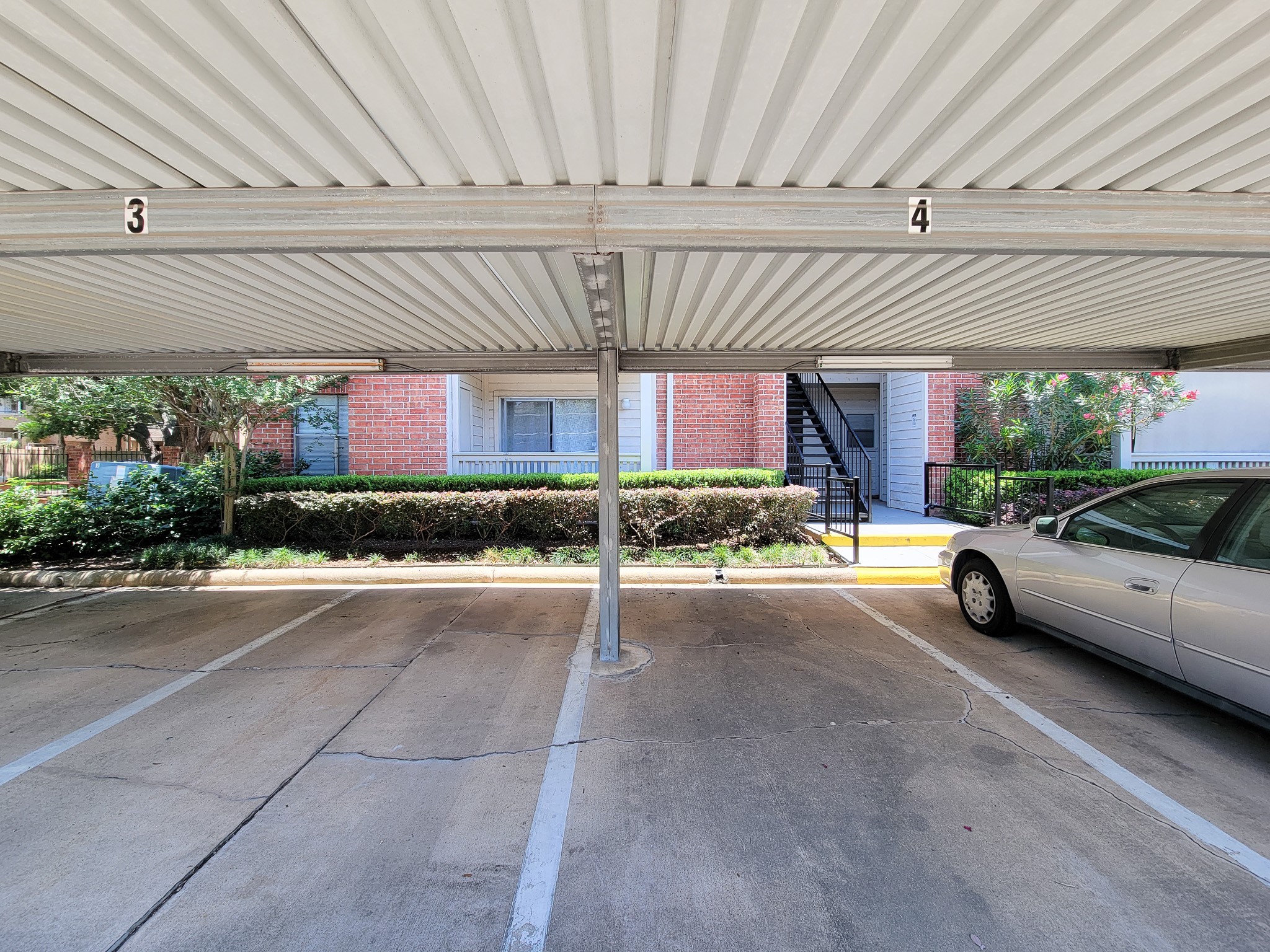 4041 Drake Street, Unit 116 Houston, TX 77005 - Photo 23 of 27 a view of a building with a patio