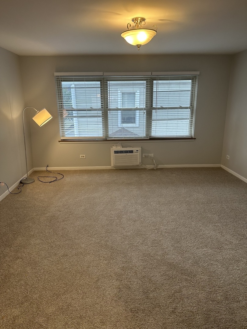 2113 West Montrose Avenue, Unit 2F Chicago, IL 60618 - Photo 5 of 8 an empty room with windows