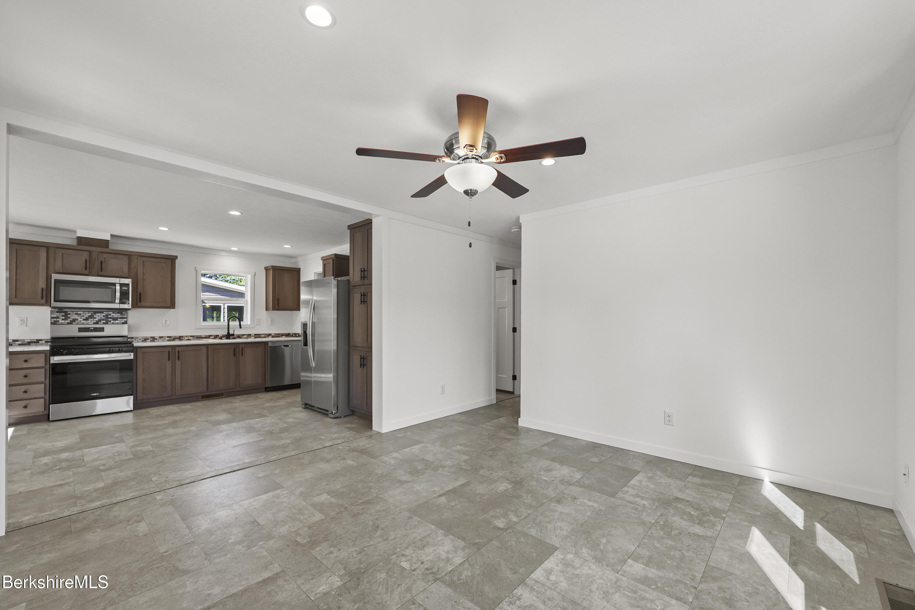 395 Cheshire Road, Unit 102 Pittsfield, MA 01201 - Photo 7 of 28 a view of a kitchen with a sink and stainless steel appliances