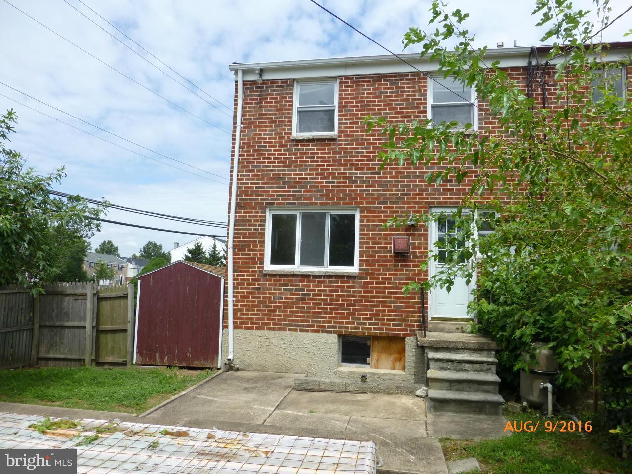948 Bayner Road Baltimore, MD 21221 - Photo 3 of 15 a view of a brick house with a yard plants and large tree