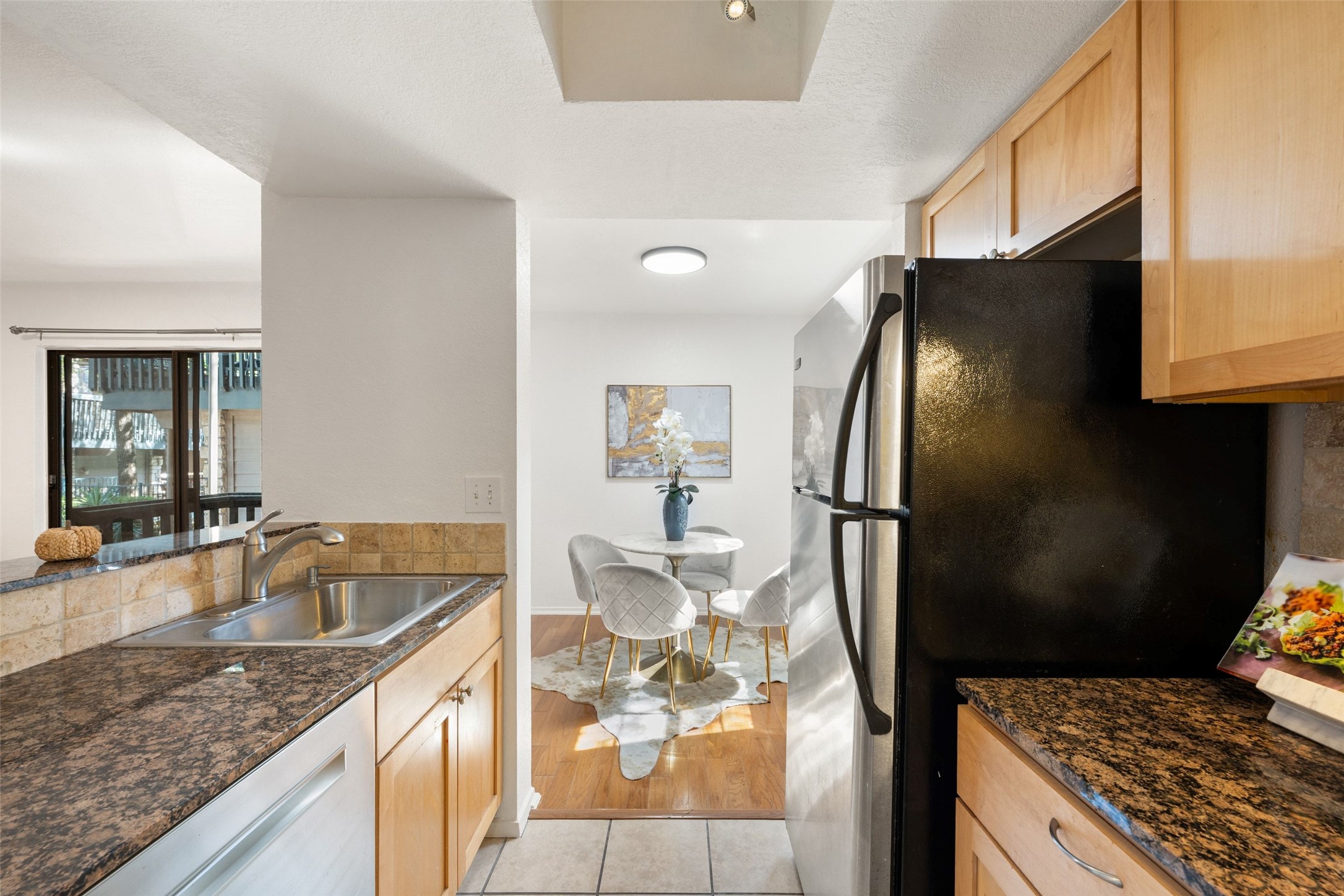 3627 Menchaca Road, Unit 105 Austin, TX 78704 - Photo 2 of 26 Kitchen with dining area and granite countertops