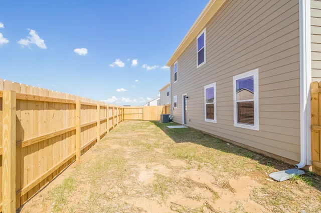a view of backyard with large windows