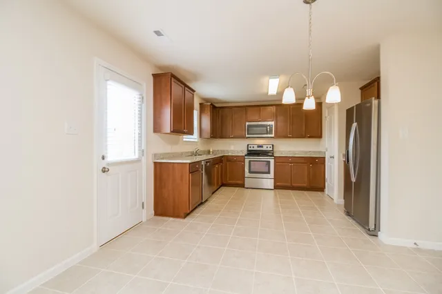 a open kitchen with cabinets a sink and stainless steel appliances