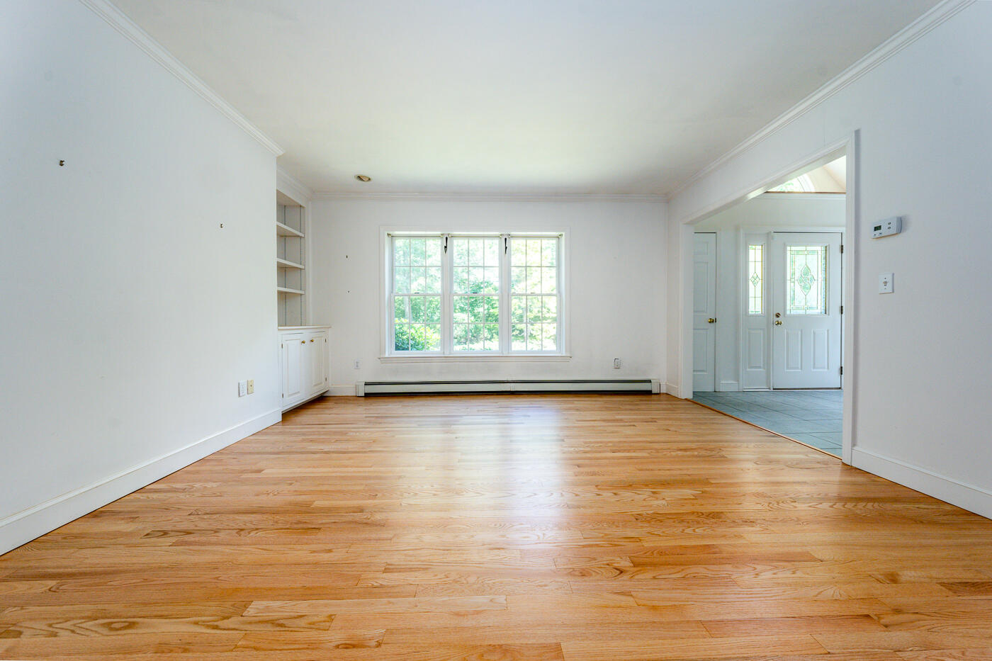 349 Little River Road Cotuit, MA 02635 - Photo 12 of 67 an empty room with wooden floor and windows