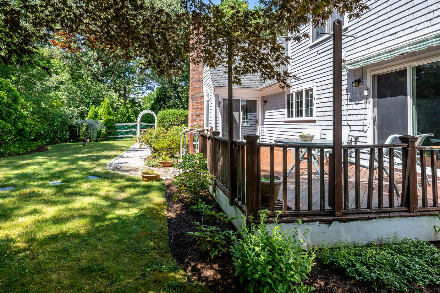 349 Little River Road Cotuit, MA 02635 - Photo 47 of 67 a view of a backyard with plants and large tree