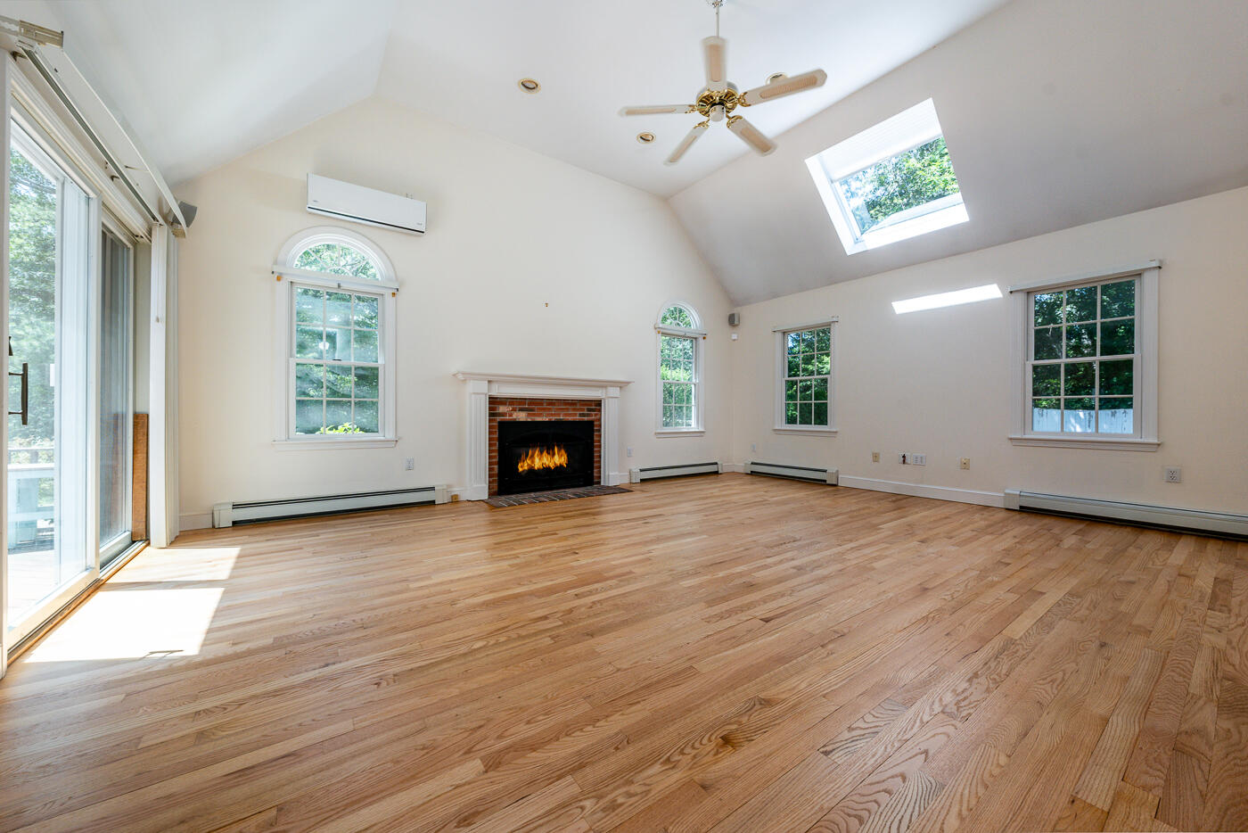 349 Little River Road Cotuit, MA 02635 - Photo 5 of 67 an empty room with windows fireplace and wooden floor