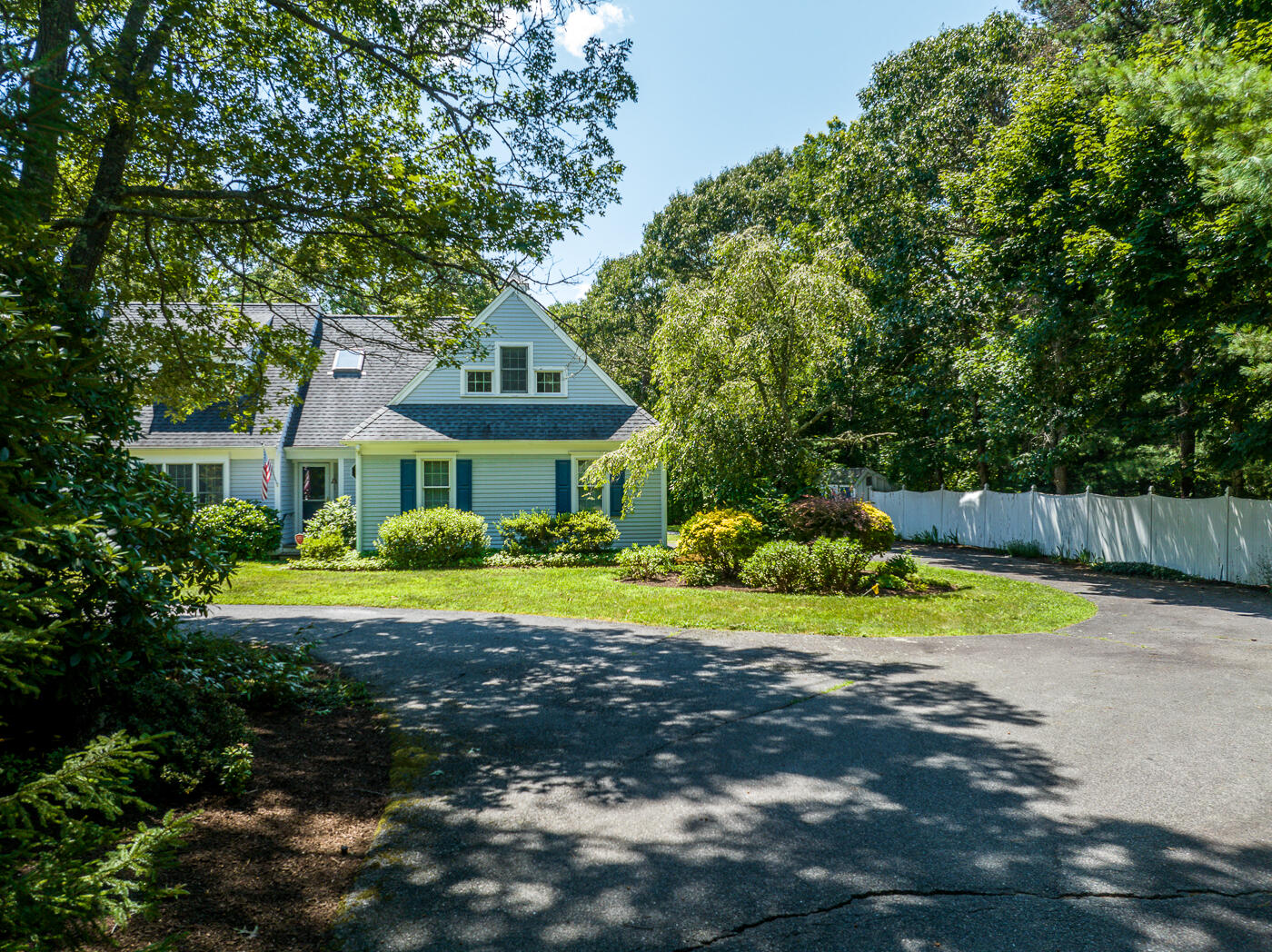 349 Little River Road Cotuit, MA 02635 - Photo 53 of 67 a front view of a house with a yard and trees