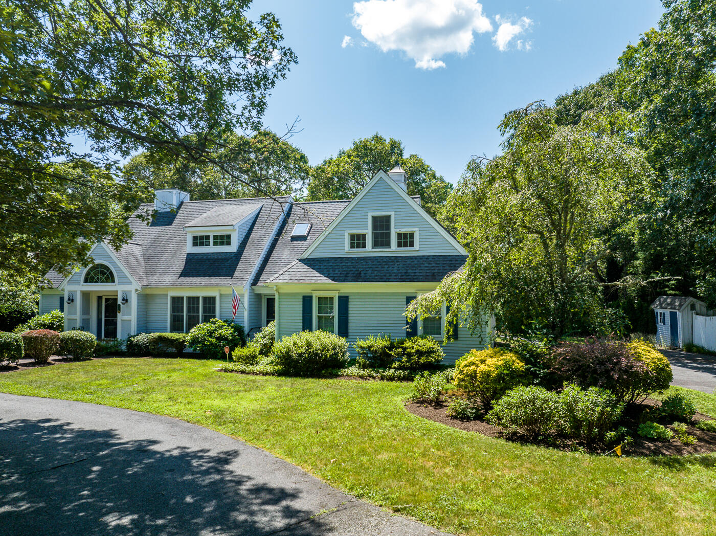 349 Little River Road Cotuit, MA 02635 - Photo 55 of 67 a front view of a house with a garden