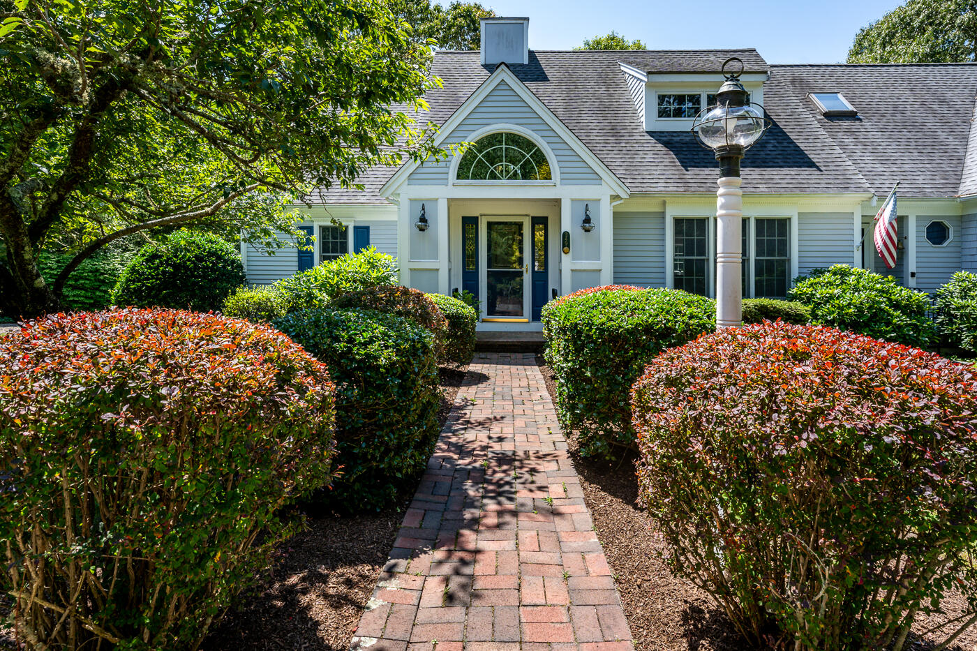 349 Little River Road Cotuit, MA 02635 - Photo 57 of 67 a view of a brick house with a yard plants and large tree