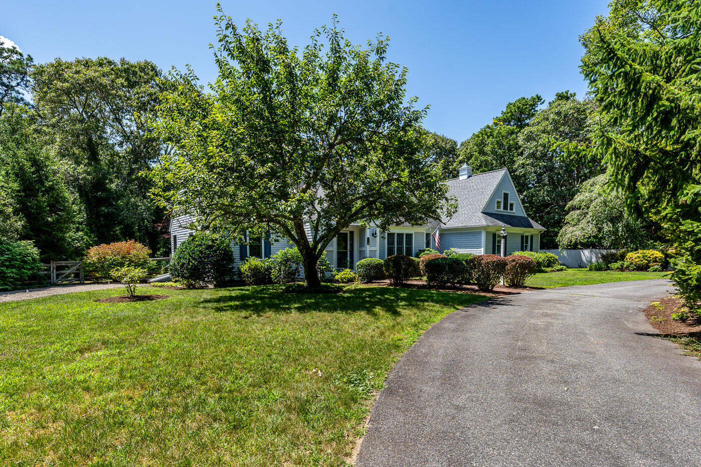 349 Little River Road Cotuit, MA 02635 - Photo 62 of 67 a front view of a house with a garden and trees