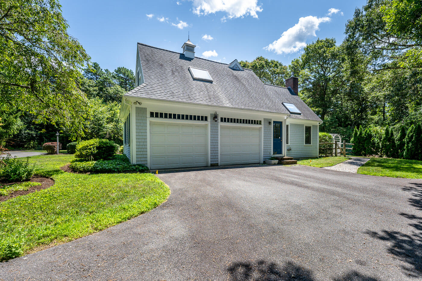 349 Little River Road Cotuit, MA 02635 - Photo 64 of 67 a front view of a house with a yard and garage