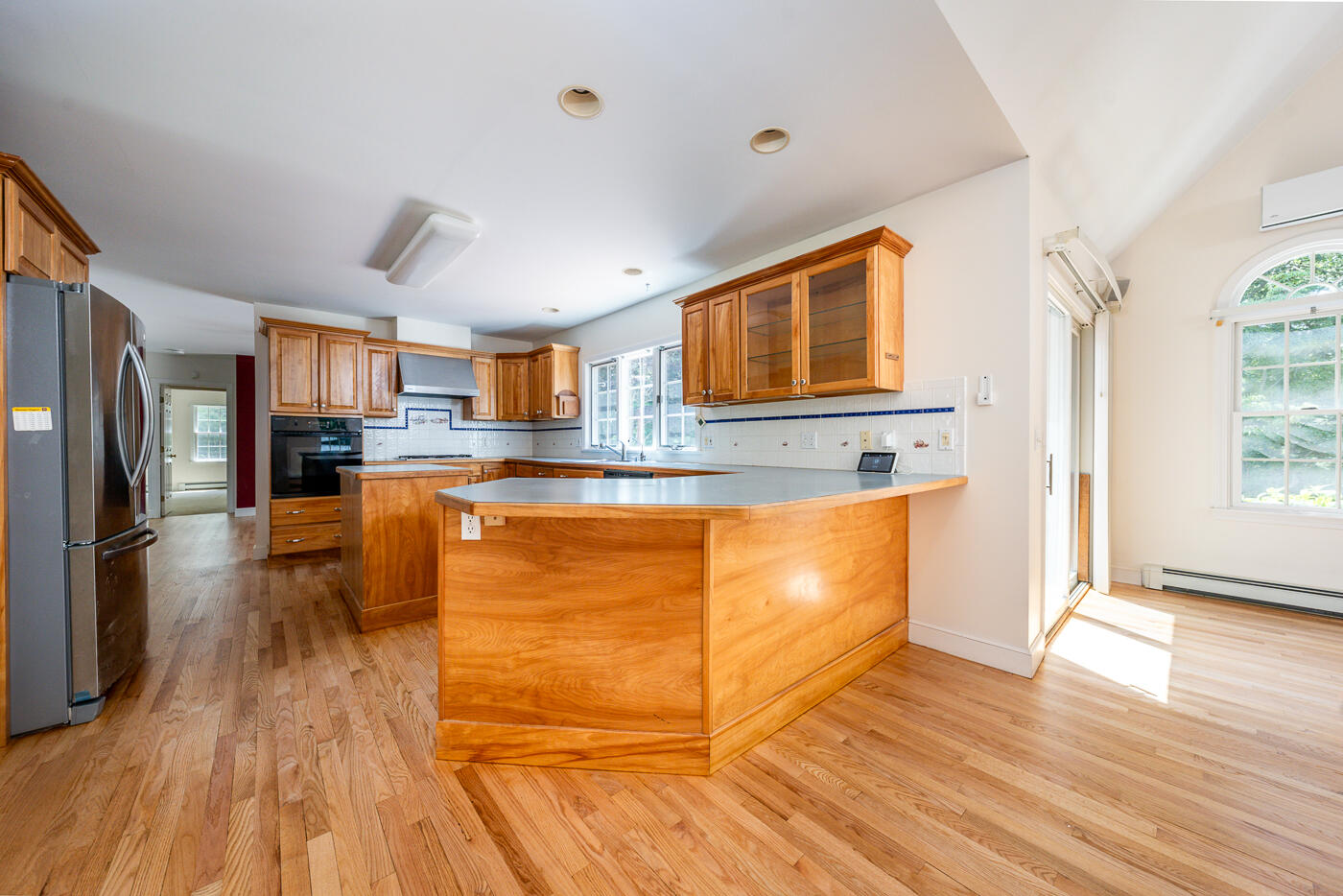 349 Little River Road Cotuit, MA 02635 - Photo 8 of 67 a kitchen with stainless steel appliances granite countertop a refrigerator a stove top oven a sink dishwasher and wooden floor
