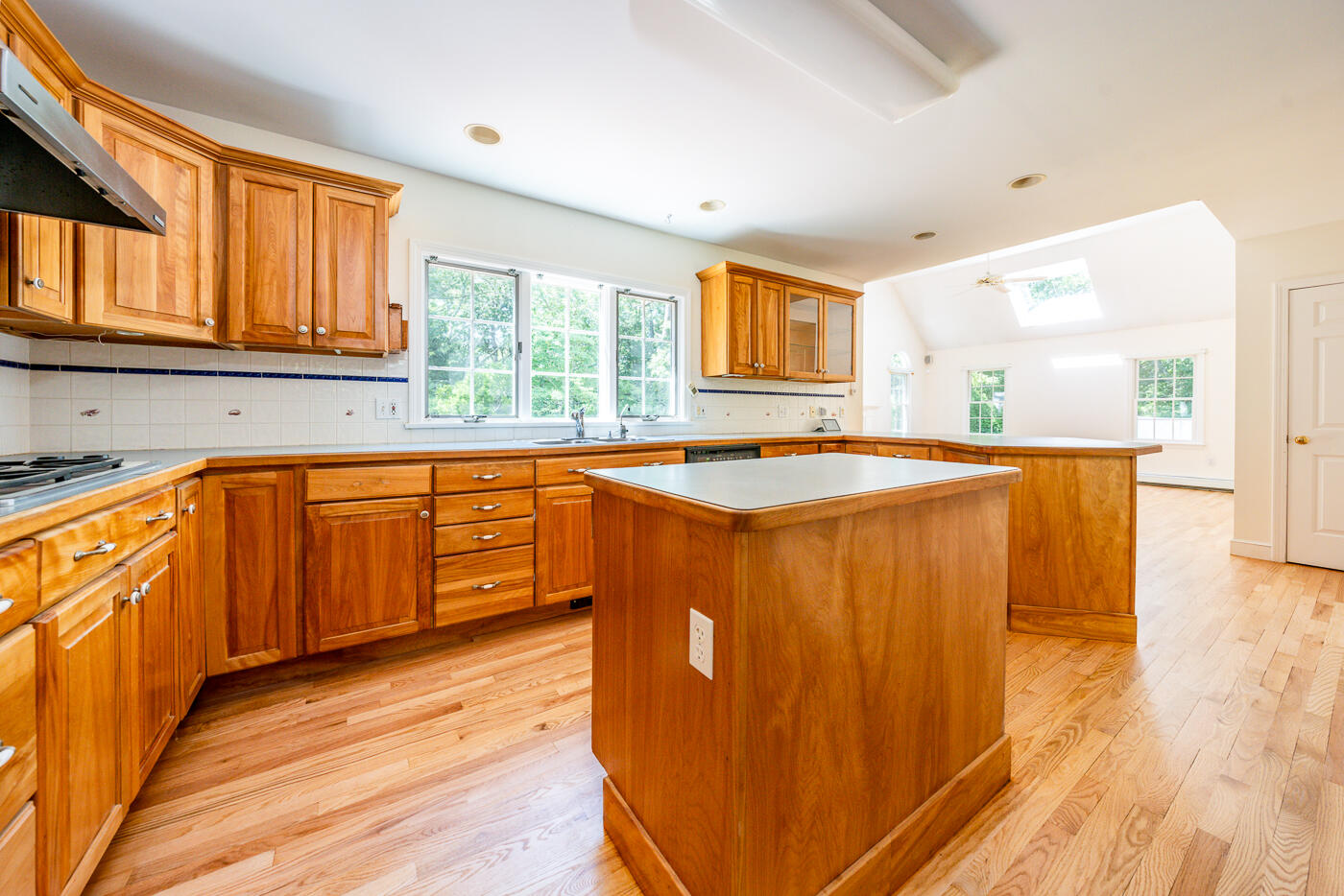 349 Little River Road Cotuit, MA 02635 - Photo 9 of 67 a kitchen with stainless steel appliances granite countertop a sink and wooden cabinets with wooden floors