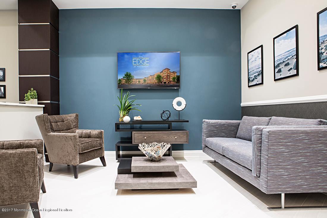 249 Broad Street, Unit 210 Matawan, NJ 07747 - Photo 26 of 27 a living room with furniture and wall paintings