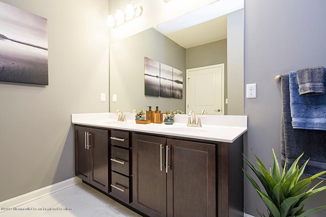 249 Broad Street, Unit 210 Matawan, NJ 07747 - Photo 7 of 27 a bathroom with a sink and a mirror