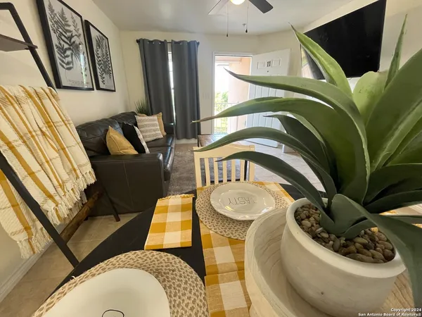a living room with furniture and a potted plant
