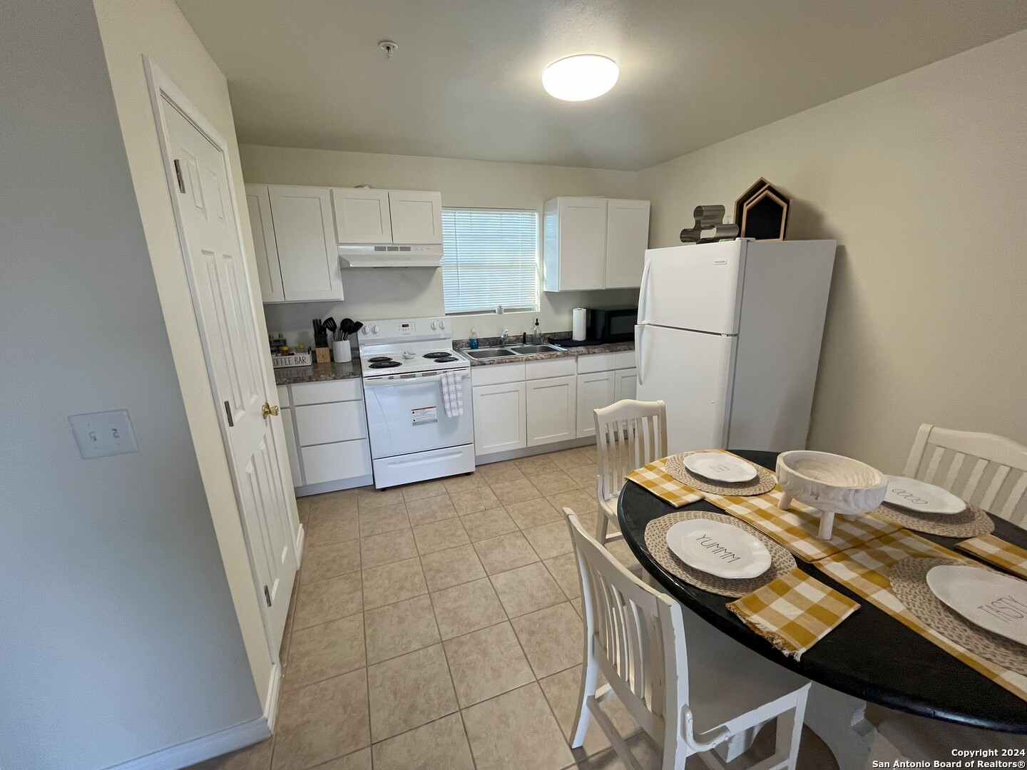 391 Riverside Drive, Unit 11 Eagle Pass, TX 78852 - Photo 3 of 14 a kitchen with a sink a stove a refrigerator and cabinetry