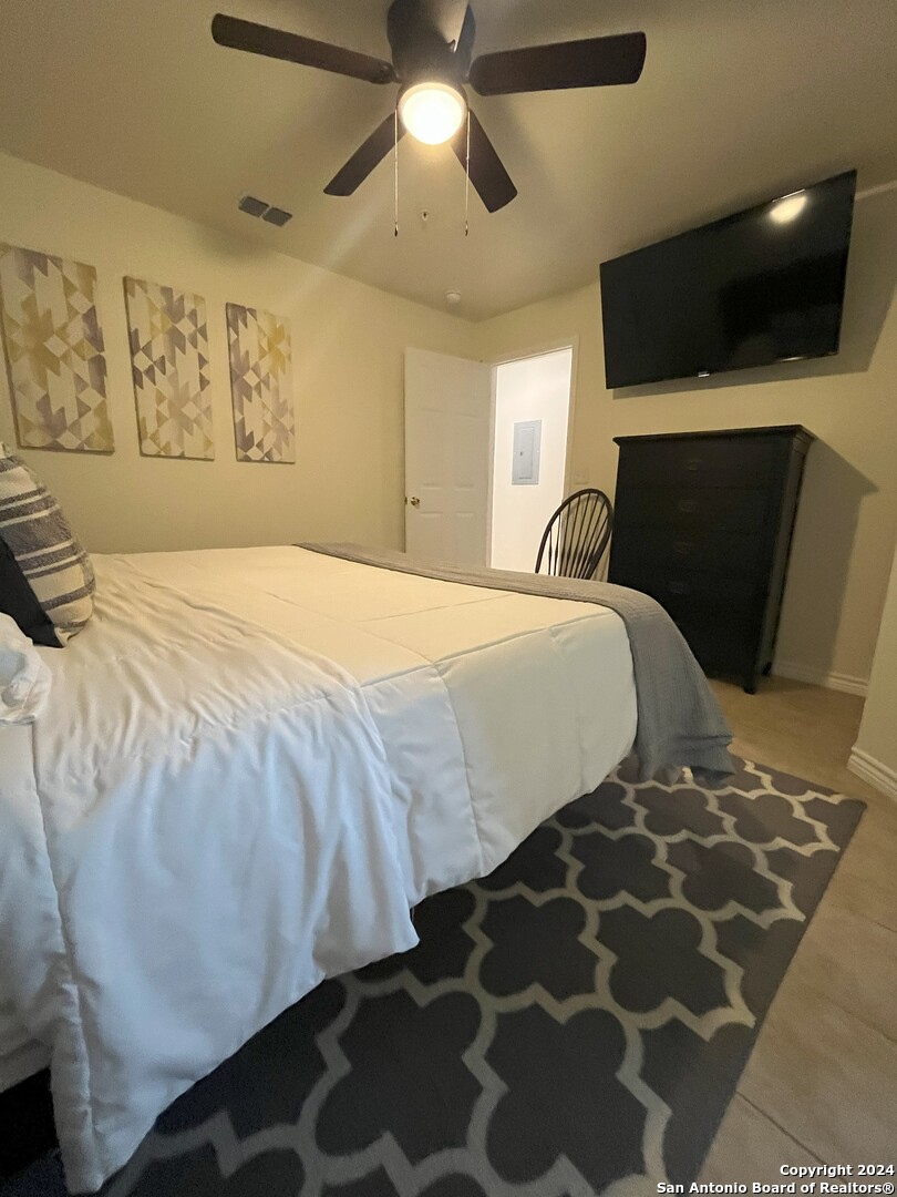 391 Riverside Drive, Unit 11 Eagle Pass, TX 78852 - Photo 7 of 14 a bedroom with a bed and a television