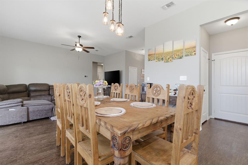 711 Hadley Lane Valley View, TX 76272 - Photo 4 of 40 Dining space featuring ceiling fan and dark wood-style flooring