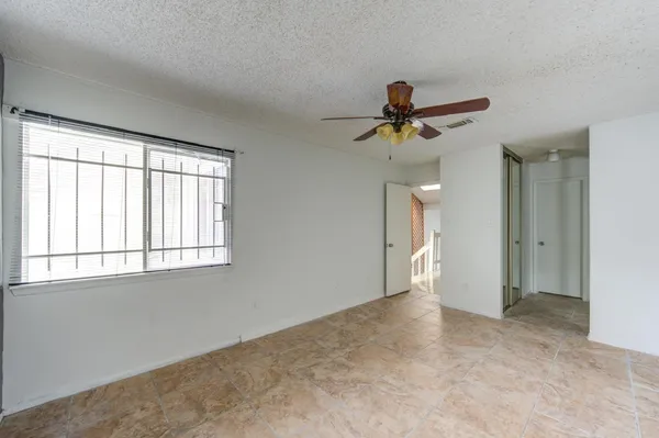 a view of a livingroom with a ceiling fan and window