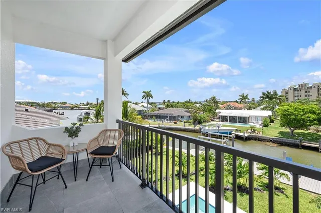 a view of a city from a balcony with furniture