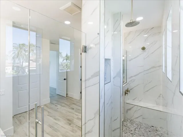 a bathroom with a shower and a glass door