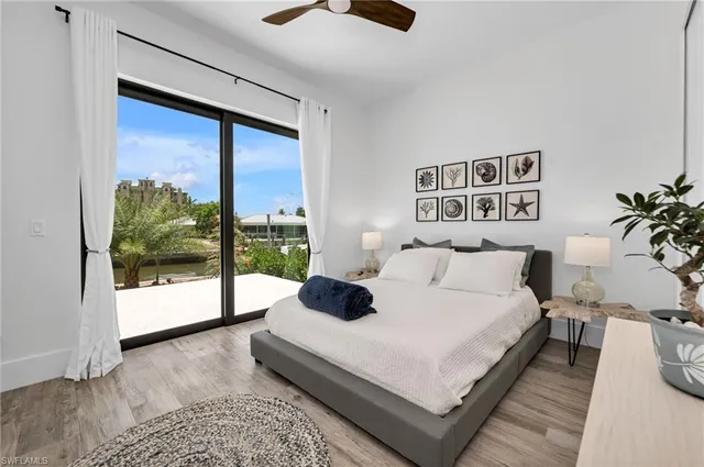 a bedroom with a large bed and a large window