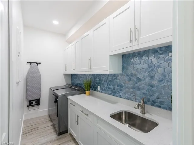a kitchen with stainless steel appliances a sink a stove and cabinets