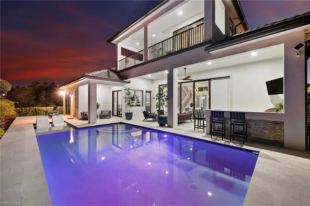 a view of a patio with couches table and chairs with barbeque grill and stairs