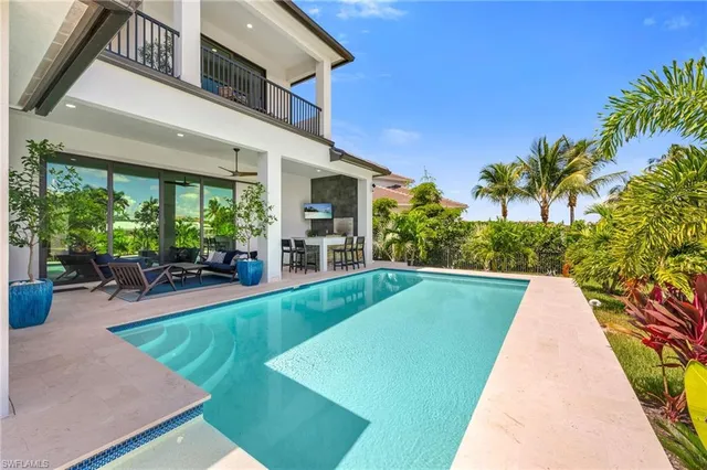 a view of swimming pool with outdoor seating and plants