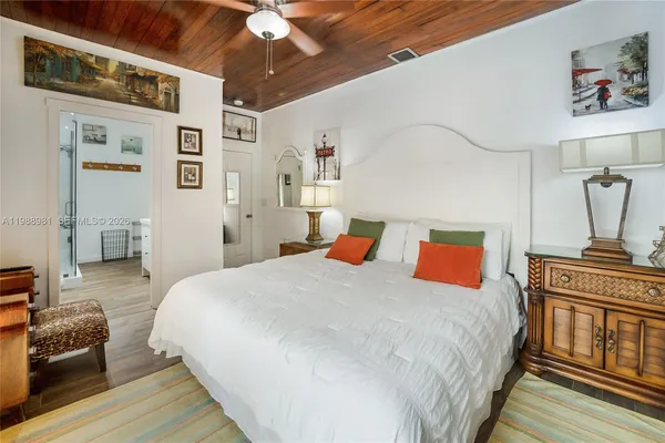 a bedroom with a large bed and a lamp