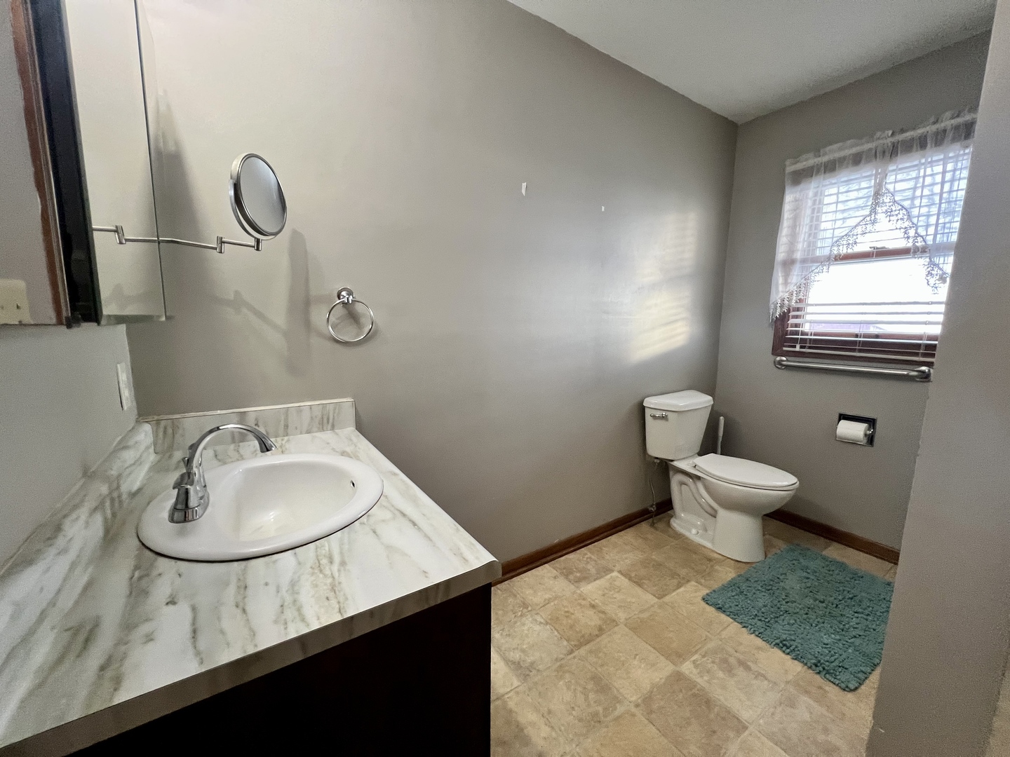 1909 County Road 2800 North Rantoul, IL 61866 - Photo 29 of 42 a bathroom with a granite countertop sink a toilet and mirror