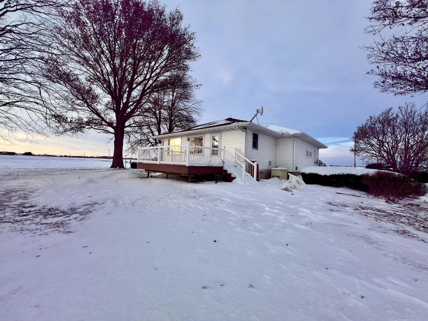 1909 County Road 2800 North Rantoul, IL 61866 - Photo 41 of 42 a yellow house with trees in front of it