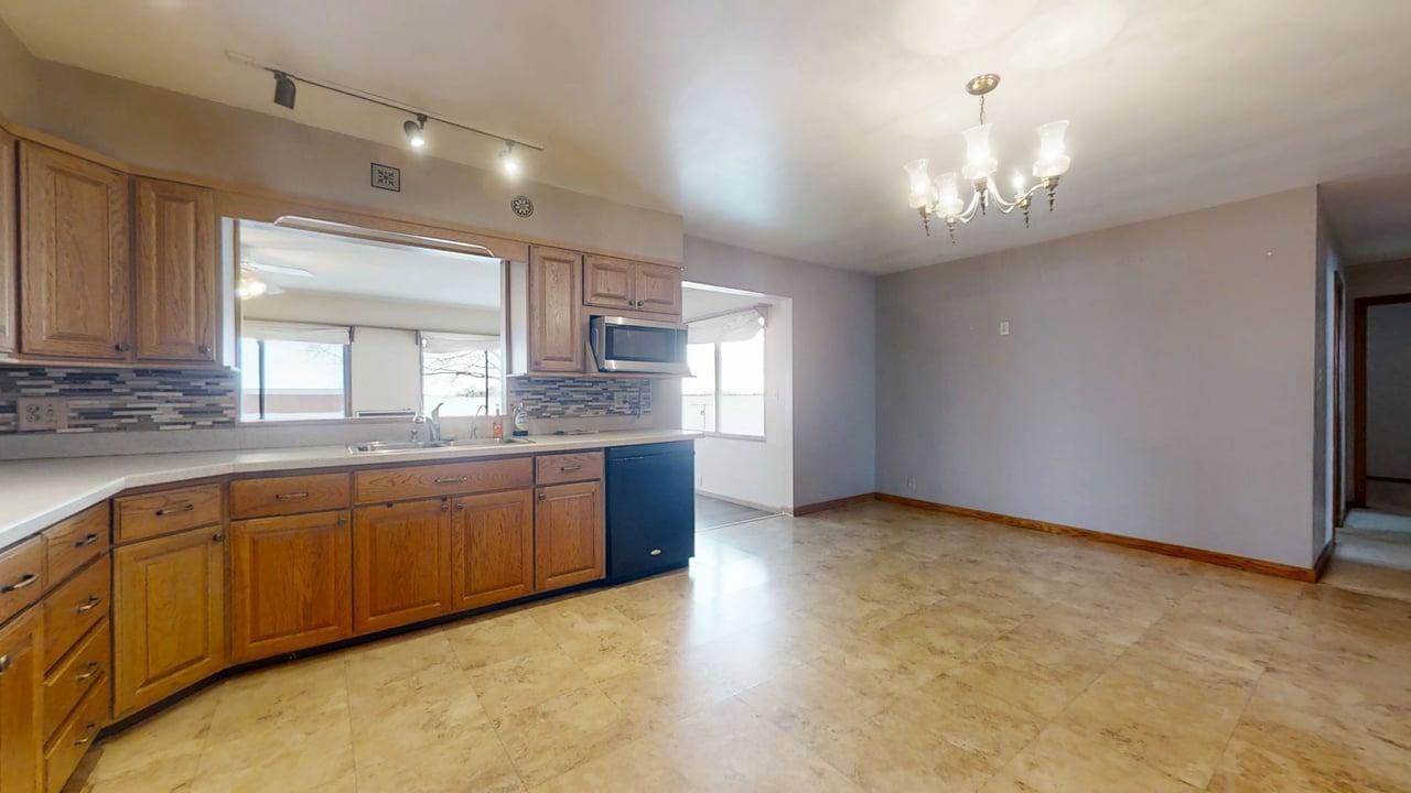 1909 County Road 2800 North Rantoul, IL 61866 - Photo 7 of 42 a large kitchen with stainless steel appliances granite countertop a sink cabinets and window