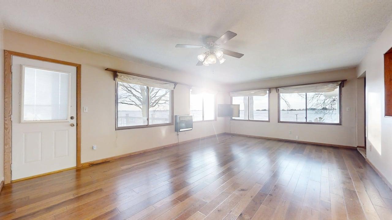 1909 County Road 2800 North Rantoul, IL 61866 - Photo 10 of 42 a view of an empty room with wooden floor and a window