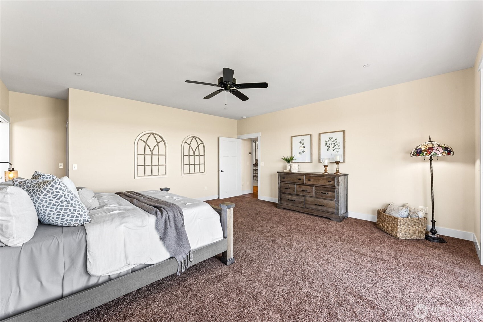 30721 40th Avenue South Roy, WA 98580 - Photo 14 of 40 a spacious bedroom with a bed a dresser and a chandelier